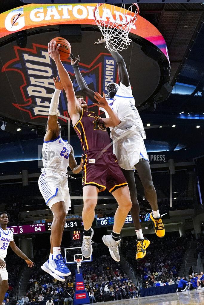 Nam Y. Huh Loyola forward Ryan Schwieger, center, drives to the basket against DePaul guard Courvoisier McCauley, left, and forward Yor Anei during the second half of an NCAA college basketball game in Chicago, Saturday, Dec. 4, 2021. (AP Photo/Nam Y. Huh)