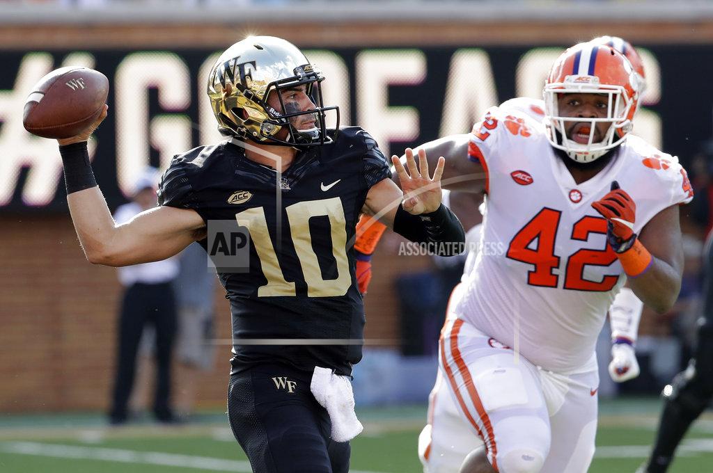 Chuck Burton Wake Forest's Sam Hartman (10) looks to pass under pressure from Clemson's Christian Wilkins (42) during the first half of an NCAA college football game in Charlotte, N.C., Saturday, Oct. 6, 2018. (AP Photo/Chuck Burton)