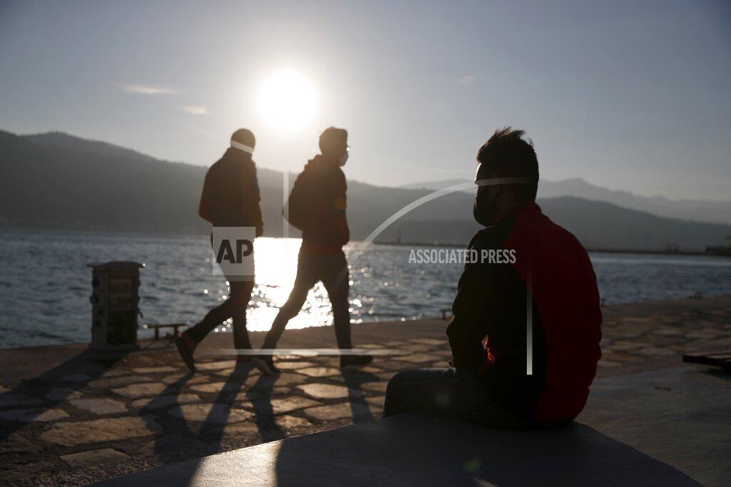 Thanassis Stavrakis An Afghan father sits on a bench at the port of Vathy on the eastern Aegean island of Samos, Greece, Monday, Feb. 22, 2021. On a hill above a small island village, the sparkling blue of the Aegean just visible through the pine trees, lies a boy’s grave. His first ever boat ride was to be his last - the sea claimed him before his sixth birthday. His 25-year-old father, like so many before him, had hoped for a better life in Europe, far from the violence of his native Afghanistan. But his dreams were dashed on the rocks of Samos, a picturesque Greek island almost touching the Turkish coast. Still devastated from losing his only child, the father has now found himself charged with a felony count of child endangerment. (AP Photo/Thanassis Stavrakis)