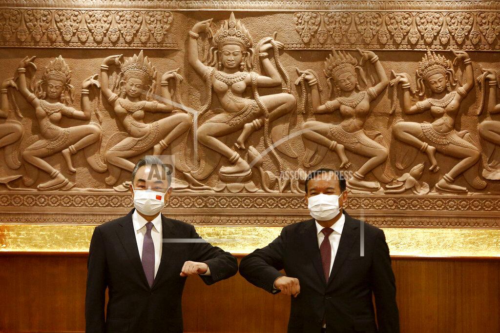 Kith Serey Chinese Foreign Minister Wang Yi, left, greets with Cambodian counterpart Prak Sokhonn in Phnom Penh, Cambodia, Sunday, Sept. 12, 2021. Wang is visiting Cambodia, where's he expected to meet with Prime Minister Hun Sen and other officials to discuss COVID-19 and other regional issues. (Kith Serey/Photo Photo via AP)