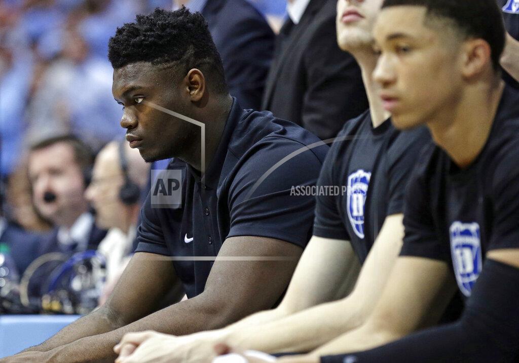 Gerry Broome Injured Duke player Zion Williamson, left, sits on the bench during the first half of an NCAA college basketball game against North Carolina in Chapel Hill, N.C., Saturday, March 9, 2019. (AP Photo/Gerry Broome)