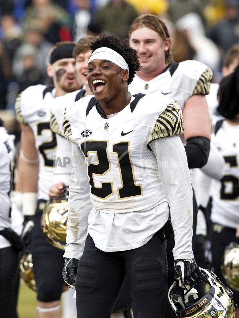Ben Mckeown Wake Forest's Essang Bassey (21) celebrates after a victory over Duke in an NCAA college football game in Durham, N.C., Saturday, Nov. 24, 2018. (AP Photo/Ben McKeown)
