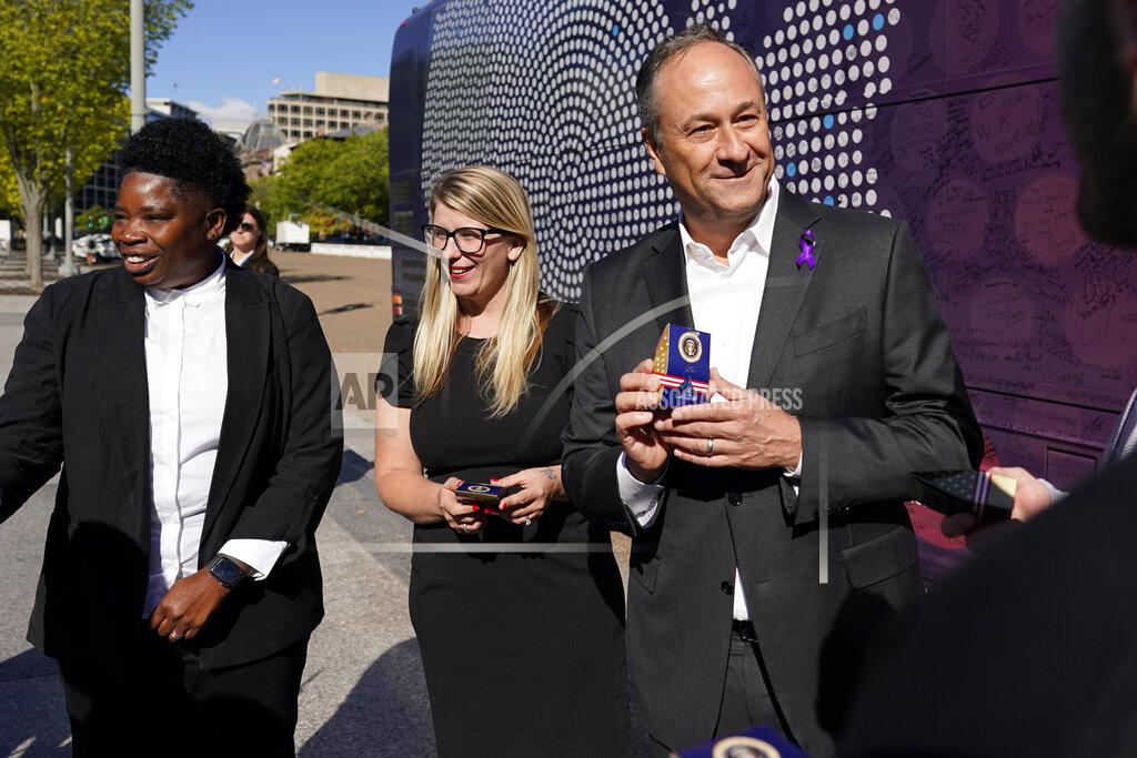 Carolyn Kaster Courtney Allen, an organizer for Mobilize Recovery and on the settlement advisory council for the state of Maine, center, Tee Scott, also an organizer at Mobilize Recovery, left, and Doug Emhoff, husband of Vice President Kamala Harris, right visit near the Mobilize Recovery bus on Pennsylvania Avenue in front of the White House in Washington, Friday, Sept. 23, 2022. Allen, Tee, and others are in Washington to meet with Emhoff to give their recommendations for the distribution of the federal settlement money as billions of dollars in opioid lawsuit settlements are starting to flow to governments. (AP Photo/Carolyn Kaster)
