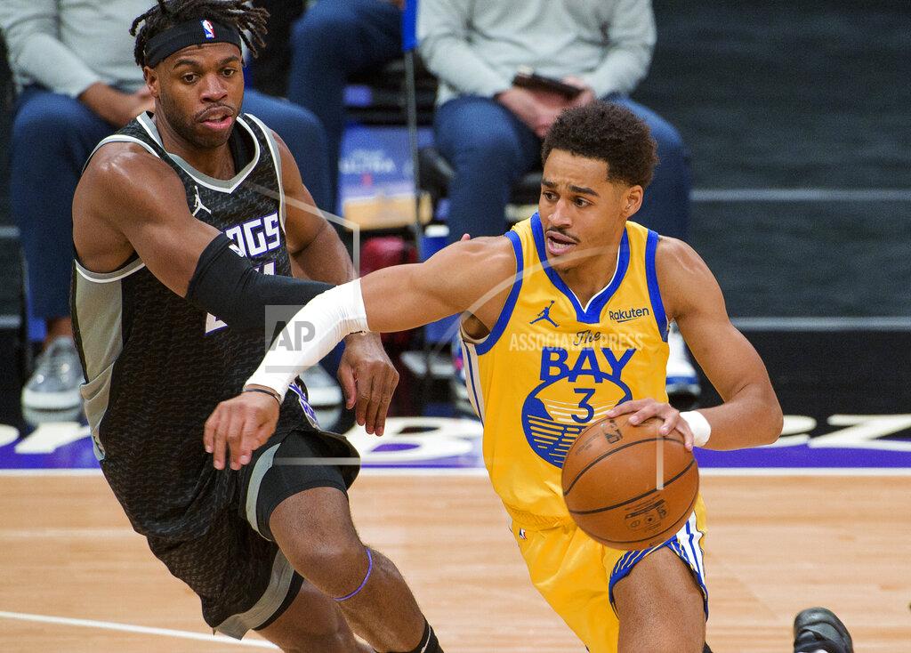 Randall Benton Sacramento Kings guard Buddy Hield, left, defends as Golden State Warriors guard Jordan Poole (3) drives during the first quarter of an NBA basketball game in Sacramento, Calif., Thursday, March 25, 2021. (AP Photo/Randall Benton)