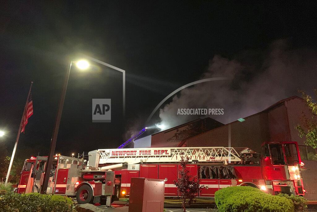 Scott Barrett Firefighters battle a fire at a recently renovated hotel in Newport, R.I., Monday, May 23, 2022. Three firefighters were injured battling the fire at the Wayfinder Hotel. (Scott Barrett/The Newport Daily News via AP)