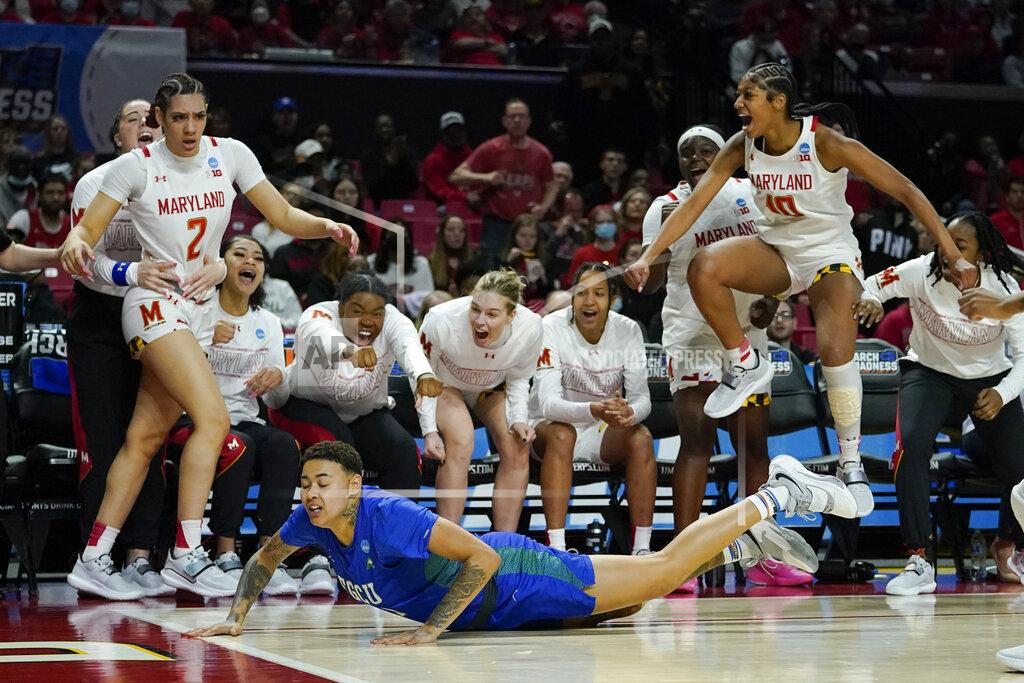 Julio Cortez Florida Gulf Coast guard Kierstan Bell, bottom, reacts after she was unable to keep the ball in bounds as the Maryland bench reacts during the second half of a college basketball game in the second round of the NCAA tournament, Sunday, March 20, 2022, in College Park, Md. Maryland won 89-65. (AP Photo/Julio Cortez)