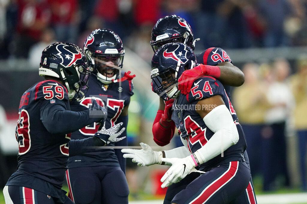 David J. Phillip Houston Texans linebacker Jake Martin (54) and outside linebacker Whitney Mercilus (59) celebrates with teammates after they sacked Indianapolis Colts quarterback Jacoby Brissett during the first half of an NFL football game Thursday, Nov. 21, 2019, in Houston. (AP Photo/David J. Phillip)