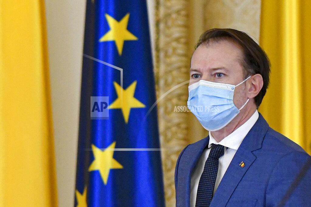 Andreea Alexandru Romanian prime minister-designate Florin Citu wears a mask for protection against the COVID-19 infections before his nomination in Bucharest, Romania, Tuesday, Dec. 22, 2020. Romania's president on Tuesday appointed the outgoing finance minister as prime minister-designate after three pro-Western center-right groups joined forces to keep out of power a left-leaning populist party that won most votes at a parliamentary election earlier this month. (AP Photo/Andreea Alexandru)