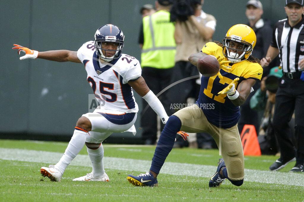 Mike Roemer Green Bay Packers wide receiver Davante Adams (17) catches a pass as Denver Broncos cornerback Chris Harris defends during the first half of an NFL football game Sunday, Sept. 22, 2019, in Green Bay, Wis. (AP Photo/Mike Roemer)