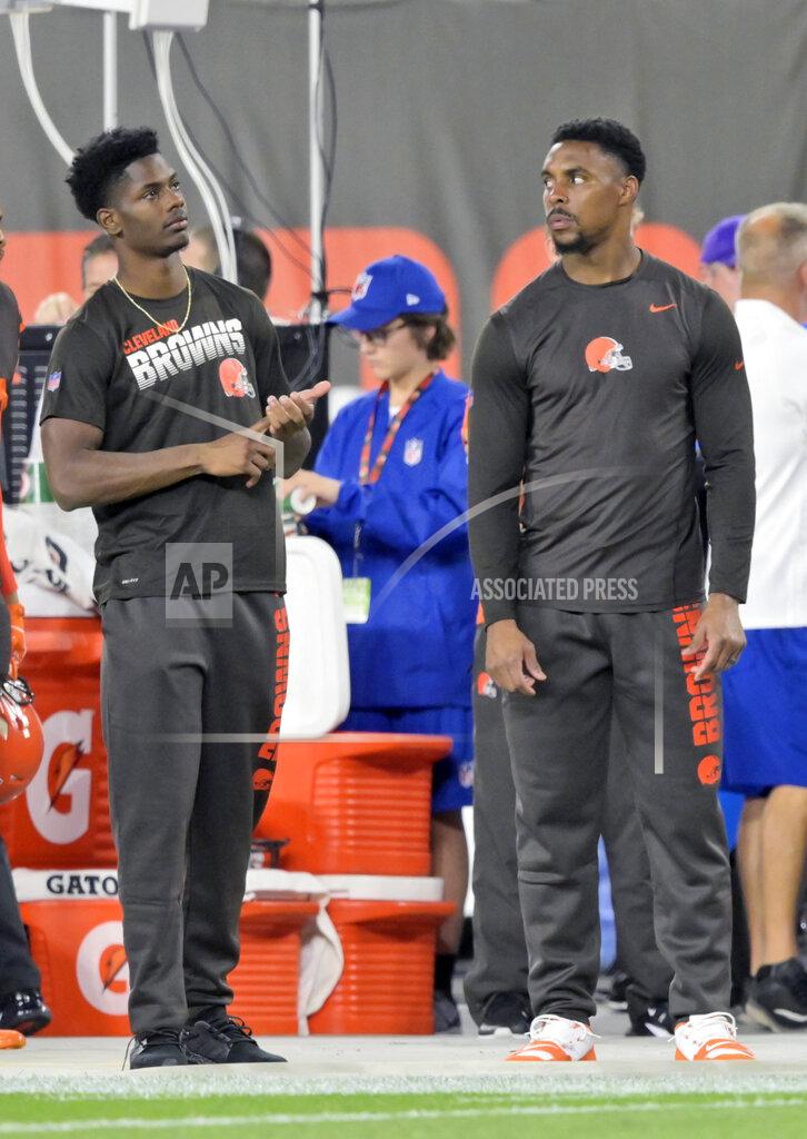 Cleveland Browns cornerback Greedy Williams, left, and strong safety Morgan Burnett watch from the sideline during the first half of an NFL football game against the Los Angeles Rams, Sunday, Sept. 22, 2019, in Cleveland. (AP Photo/David Richard)