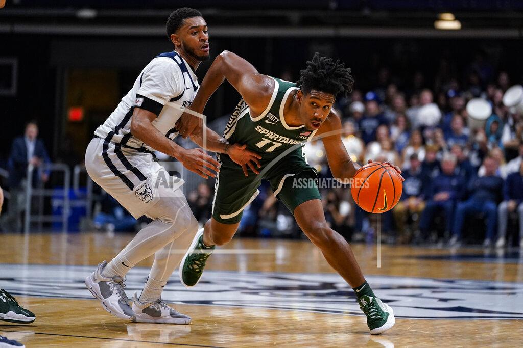 Michael Conroy Michigan State guard A.J. Hoggard (11) drives away from Butler guard Aaron Thompson (2) in the second half of an NCAA college basketball game in Indianapolis, Wednesday, Nov. 17, 2021. Michigan State defeated Butler 73-52. (AP Photo/Michael Conroy)