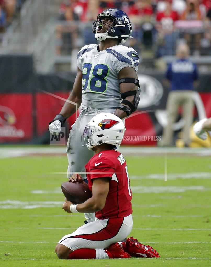 Rick Scuteri Arizona Cardinals quarterback Kyler Murray (1) kneels on the turf after being tackled by Seattle Seahawks defensive end Rasheem Green (98) during the first half of an NFL football game, Sunday, Sept. 29, 2019, in Glendale, Ariz. (AP Photo/Rick Scuteri)