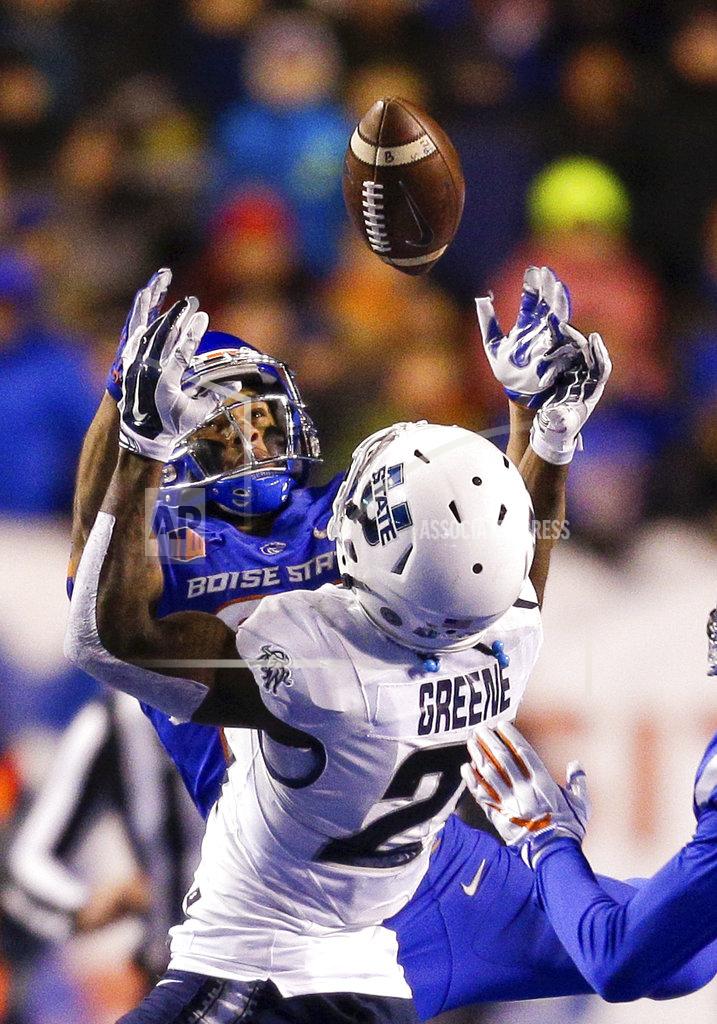 Steve Conner Boise State cornerback Avery Williams, left, battles with Utah State wide receiver Jalen Greene (21) for the ball on a pass in the second of an NCAA college football game, Saturday, Nov. 24, 2018, in Boise, Idaho. Boise State won 33-24. (AP Photo/Steve Conner)