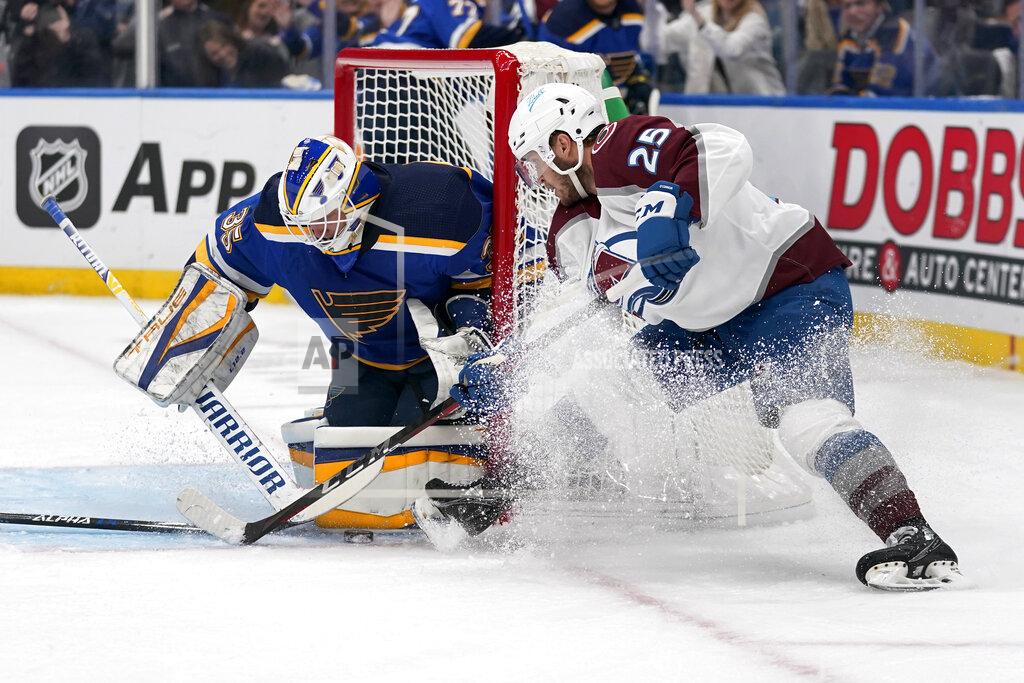 Jeff Roberson St. Louis Blues goaltender Ville Husso, left, stops a shot from Colorado Avalanche's Logan O'Connor (25) during the first period in Game 4 of an NHL hockey Stanley Cup second-round playoff series Monday, May 23, 2022, in St. Louis. (AP Photo/Jeff Roberson)