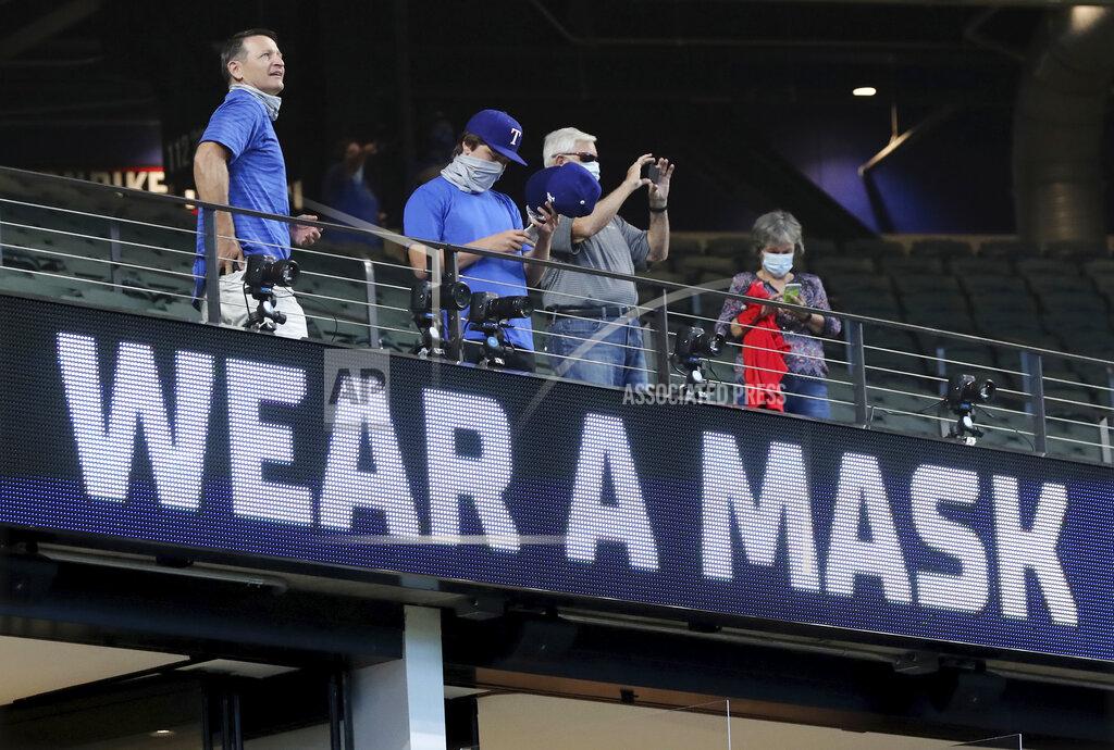 Curtis Compton Texas Rangers fans arrive to watch the Atlanta Braves play the Los Angeles Dodgers in Game 1 of a baseball National League Championship Series, Monday, Oct. 12, 2020, in Arlington, Texas. (Curtis Compton/Atlanta Journal-Constitution via AP)