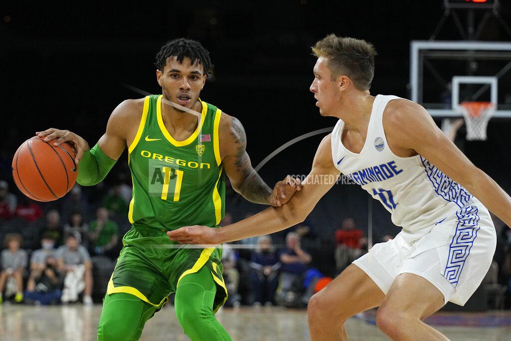 Rick Scuteri Oregon guard Rivaldo Soares (11) drives against Chaminade forward Zach McIntire in the first half during an NCAA college basketball game at the Maui Invitational in Las Vegas, Monday, Nov. 22, 2021. (AP Photo/Rick Scuteri)