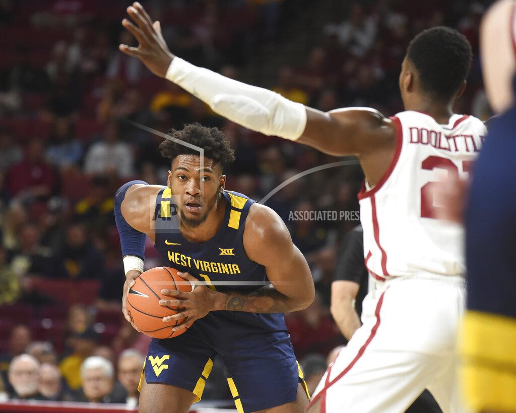 Kyle Phillips West Virginia forward Derek Culver (1) looks for an opening against Oklahoma forward Kristian Doolittle (21) during the first half of an NCAA college basketball game in Norman, Okla., Saturday, Feb. 8, 2020. (AP Photo/Kyle Phillips)