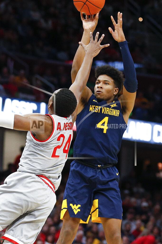 West Virginia's Miles McBride (4) shoots over Ohio State's Andre Wesson (24) during the second half of an NCAA college basketball game Sunday, Dec. 29, 2019, in Cleveland. West Virginia defeated Ohio State 67-59. (AP Photo/Ron Schwane)