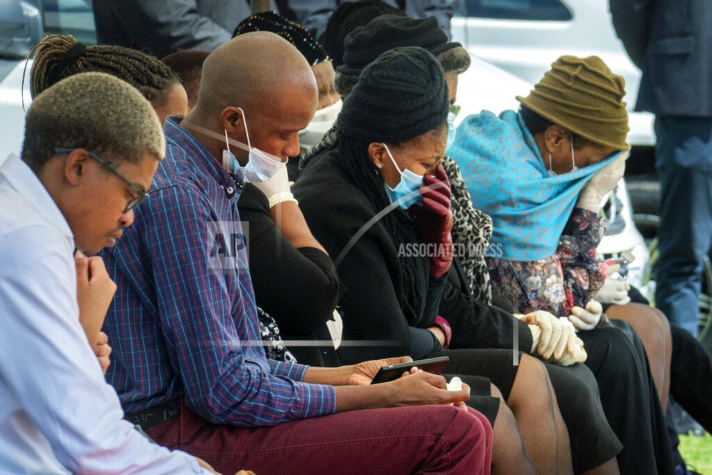 Jerome Delay Family and friends mourn Benedict Somi Vilakasi at his burial ceremony at the Nasrec Memorial Park outside Johannesburg Thursday, April 16, 2020. Vilakasi, a Soweto coffee shop manager, died of Covid-19 infection in a Johannesburg hospital Sunday April 12 2020. South Africa is under a strict five-week lockdown in a effort to fight the Coronavirus pandemic.(AP Photo/Jerome Delay)