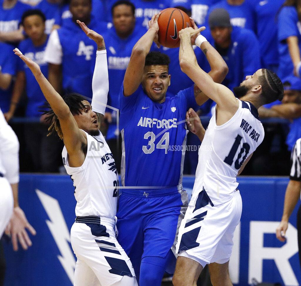 David Zalubowski Air Force forward Ryan Swan, center, looks to pass the ball under pressure from Nevada guard Jazz Johnson, left, and forward Caleb Martin during the first half of an NCAA college basketball game Tuesday, March 5, 2019, at Air Force Academy, Colo.(AP Photo/David Zalubowski)