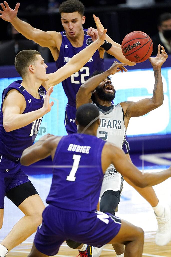 Nam Y. Huh Chicago State guard Levelle Zeigler (2) can't control the ball as Northwestern forward Pete Nance (22), forward Miller Kopp, left, and guard Chase Audige guard during the first half of an NCAA college basketball game in Evanston, Ill., Saturday, Dec. 5, 2020. (AP Photo/Nam Y. Huh)