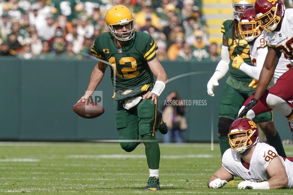 Morry Gash Green Bay Packers' Aaron Rodgers runs for a first down during the first half of an NFL football game against the Washington Football Team Sunday, Oct. 24, 2021, in Green Bay, Wis. (AP Photo/Morry Gash)