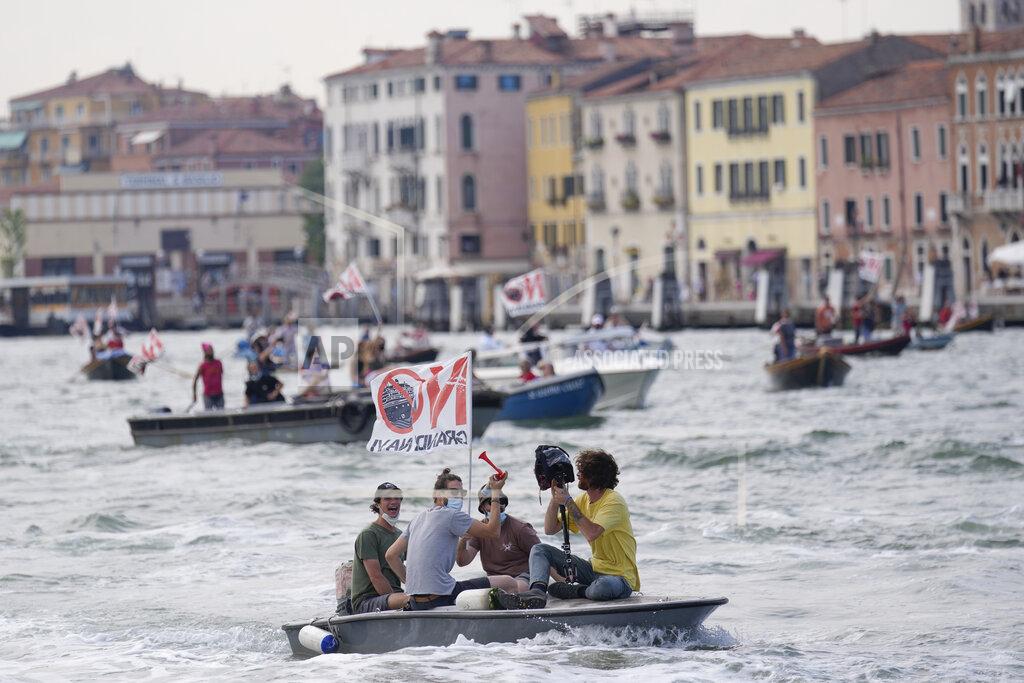 Antonio Calanni "No Big Ships" activists stage a protest as the MSC Orchestra cruise ship leaves Venice, Italy, Saturday, June 5, 2021. The 92,409-ton, 16-deck MSC Orchestra cruise ship, the first cruise ship leaving Venice since the pandemic is set to depart Saturday amid protests by activists demanding that the enormous ships be permanently rerouted out the fragile lagoon, especially Giudecca Canal through the city's historic center, due to environmental and safety risks. The ship passed two groups of protesters: pro-cruise advocates whose jobs depend on the industry as well as protesters who have been campaigning for years to get cruise ships out of the lagoon. The cruiser passed two groups of protesters: pro-cruise advocates whose jobs depend on the industry as well as protesters who have been campaigning for years to get cruise ships out of the lagoon. (AP Photo/Antonio Calanni)