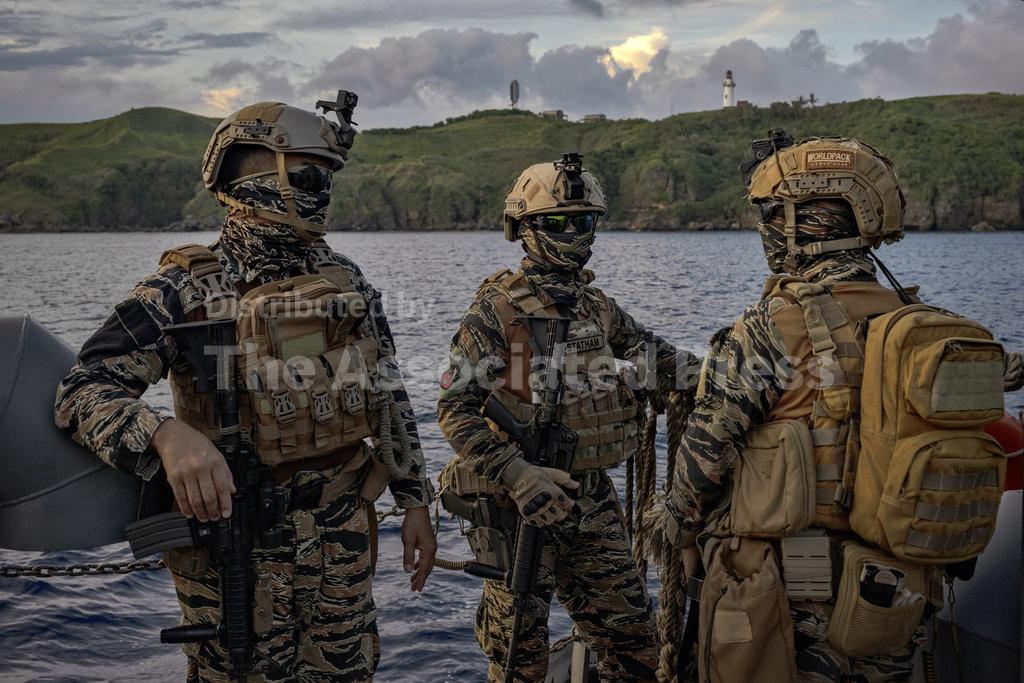 Mapi Army Filipino soldiers ride a barge on Thursday, June 29, 2023, in Basco ...