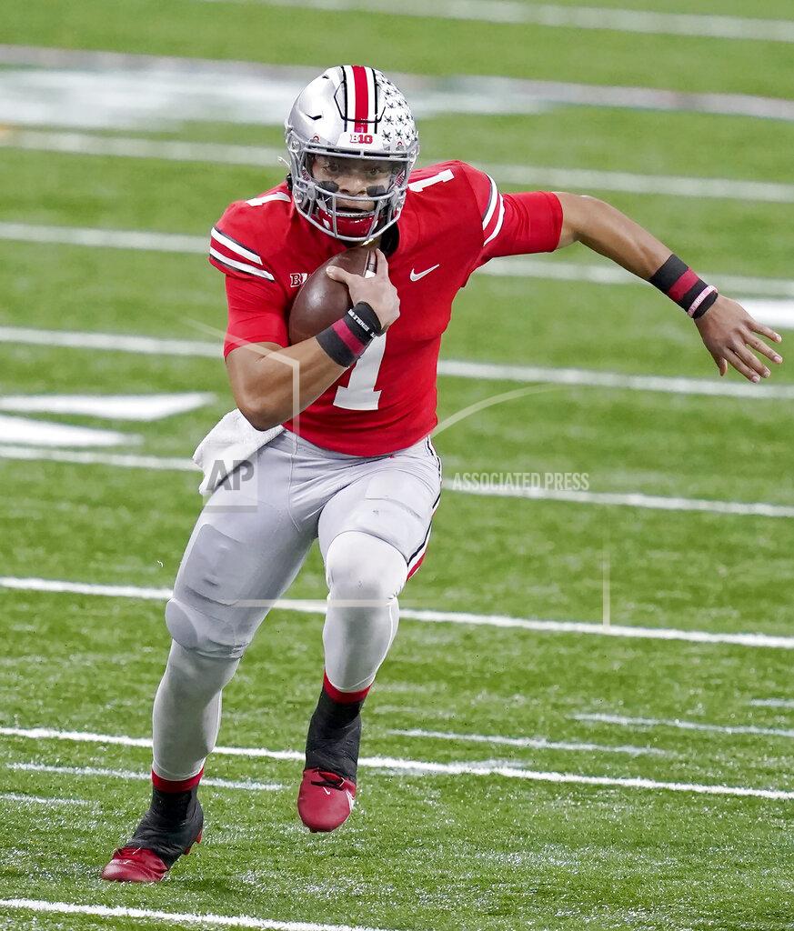 Darron Cummings FILE - Ohio State quarterback Justin Fields runs with the ball during the first half of the Big Ten championship NCAA college football game against Northwestern in Indianapolis, in this Saturday, Dec. 19, 2020, file photo. Fields is a likely first round pick in the NFL Draft, April 29-May 1, 2021, in Cleveland.(AP Photo/Darron Cummings, File)