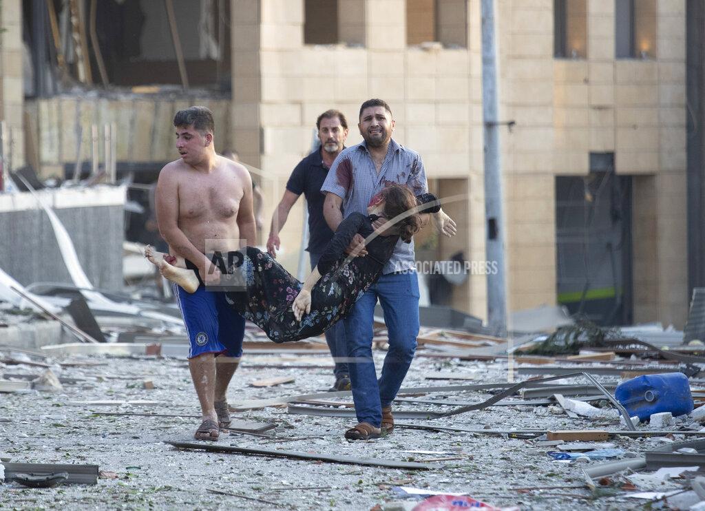 Hassan Ammar Wounded people are evacuated after a massive explosion in Beirut, Lebanon, Tuesday, Aug. 4, 2020. Massive explosions rocked downtown Beirut on Tuesday, flattening much of the port, damaging buildings and blowing out windows and doors as a giant mushroom cloud rose above the capital. Witnesses saw many people injured by flying glass and debris. (AP Photo/Hassan Ammar)