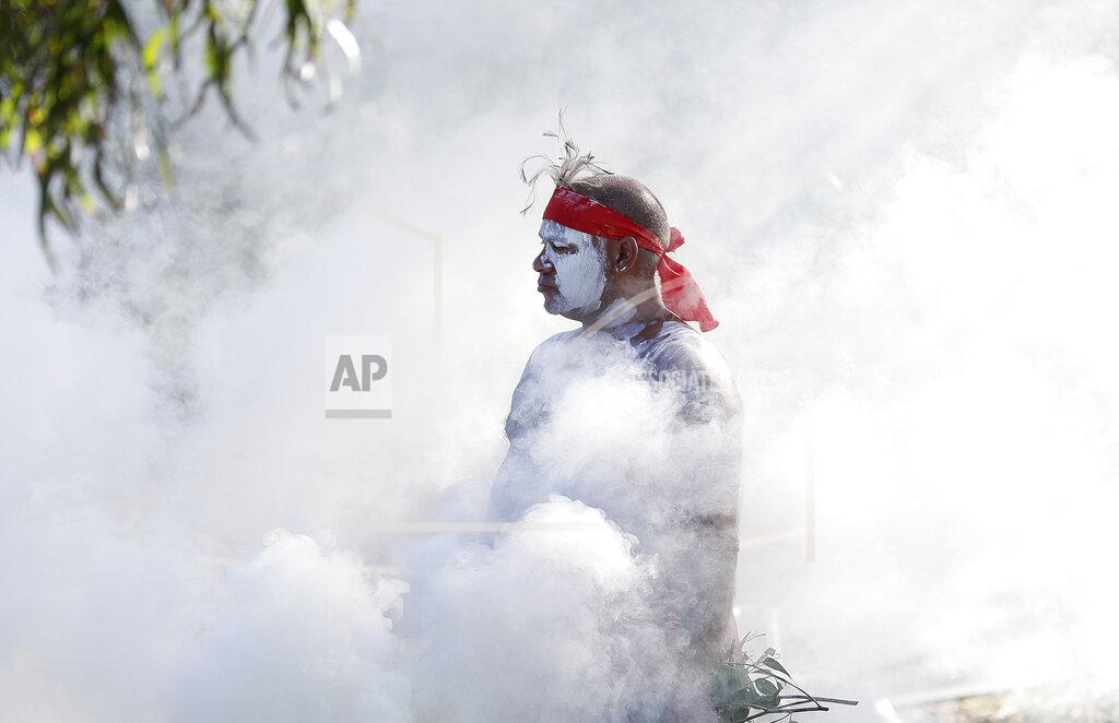 Rick Rycroft Russell Dawson of the Koomurri Aboriginal Dancers participates in a smoking ceremony during Australia Day ceremonies in Sydney, Tuesday, Jan. 26, 2021. (AP Photo/Rick Rycroft)