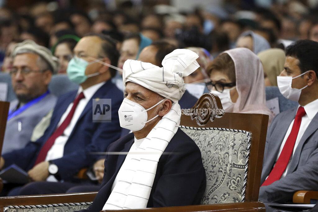 Rahmat Gul Afghan President Ashraf Ghani, center, wearing a protective face mask to help curb the spread of the coronavirus, attends an Afghan Loya Jirga meeting in Kabul, Afghanistan, Friday, Aug. 7, 2020. The traditional council opened Friday in the Afghan capital to decide the release of a final 400 Taliban - the last hurdle to the start of negotiations between Kabul’s political leadership and the Taliban in keeping with a peace deal the United States signed with the insurgent movement in February. (AP Photo/Rahmat Gul)