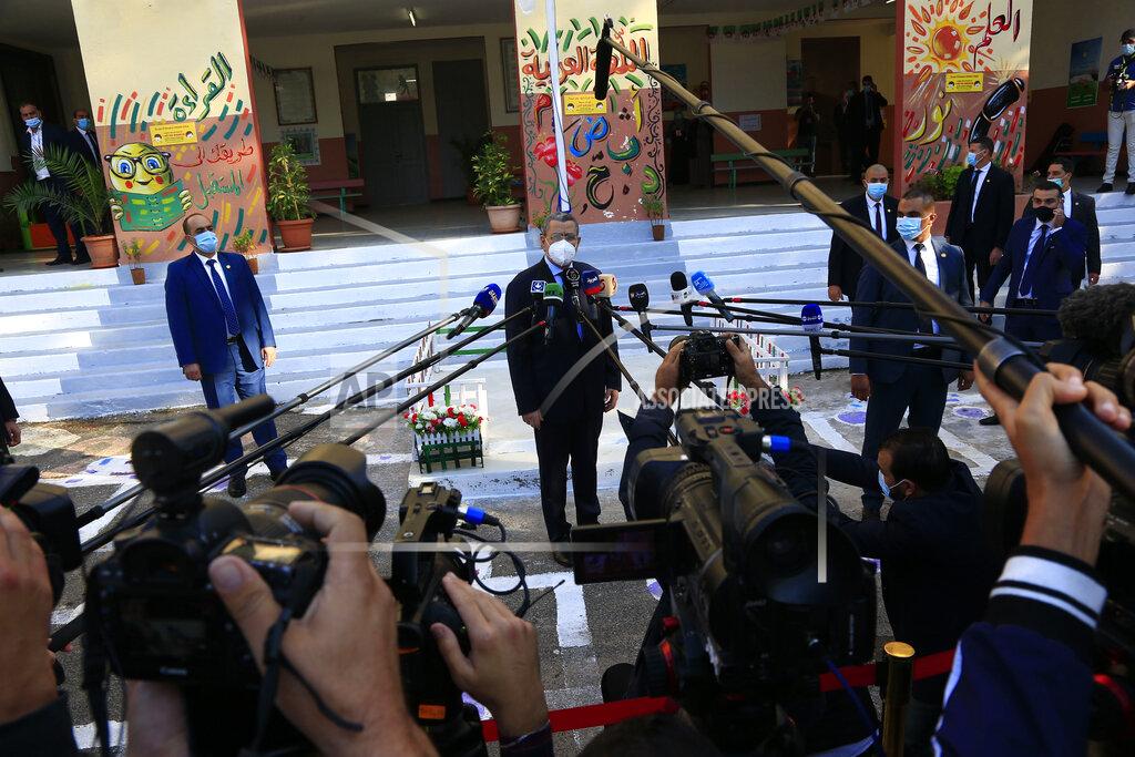 Toukik Doudou Algerian Prime Minister Abdelaziz Djerad, center, delivers a speech after he casts his ballot at a polling station during a vote for a revised constitution, in Algiers, Sunday, Nov. 1, 2020. Algerians are voting on whether to approve a revised constitution that imposes term limits and aims at answering demands from pro-democracy protesters who pushed out the president last year. (AP Photo/Toufik Doudou)