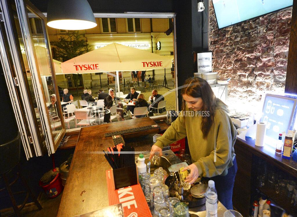 Czarek Sokolowski People gather and celebrate as bars, clubs and other establishments reopened in Poland after being closed for seven months, in Warsaw, Poland, Friday, May 14, 2021.(AP Photo/Czarek Sokolowski)