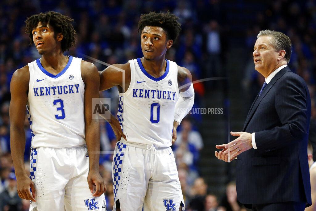 James Crisp Kentucky's Tyrese Maxey (3), and Ashton Hagans (0), listen as head coach John Calipari instructs them during the second half of an NCAA college basketball game in Lexington, Ky., Saturday, Jan 4, 2020. Kentucky won 71-59. (AP Photo/James Crisp)