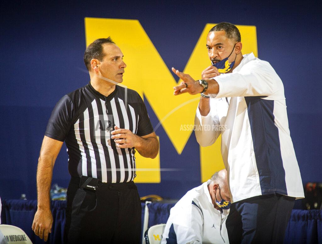 Tony Ding Michigan head coach Juwan Howard, right, speaks with game official Bo Boroski courtside in the first half of an NCAA college basketball game against Oakland at Crisler Center in Ann Arbor, Mich., Sunday, Nov. 29, 2020. (AP Photo/Tony Ding)