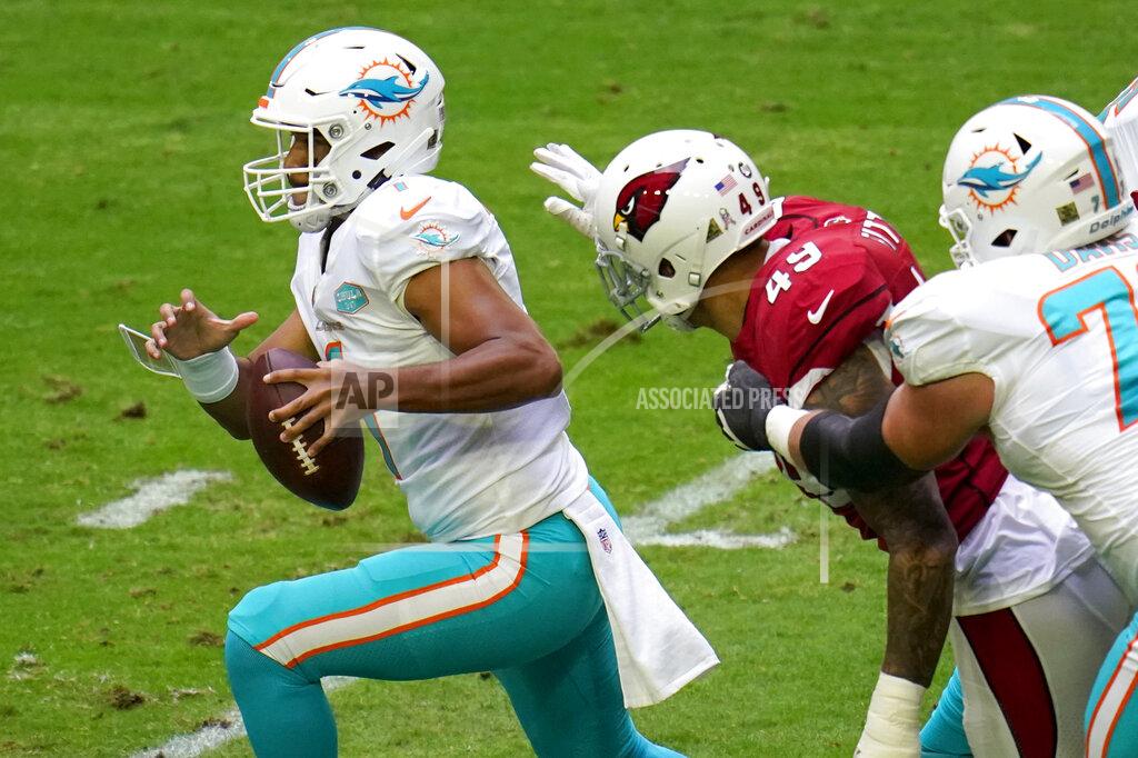 Ross D. Franklin Miami Dolphins quarterback Tua Tagovailoa (1) tries to escape the reach of Arizona Cardinals linebacker Kylie Fitts (49) during the first half of an NFL football game, Sunday, Nov. 8, 2020, in Glendale, Ariz. (AP Photo/Ross D. Franklin)
