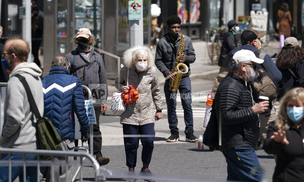 Mark Lennihan People walk on the street, Monday, April 26, 2021 in New York. The once-a-decade head count of the United States shows where the population grew during the past 10 years and where it shrank. New York will lose one seat in Congress as a result of national population shifts, according to census data released Monday. (AP Photo/Mark Lennihan)