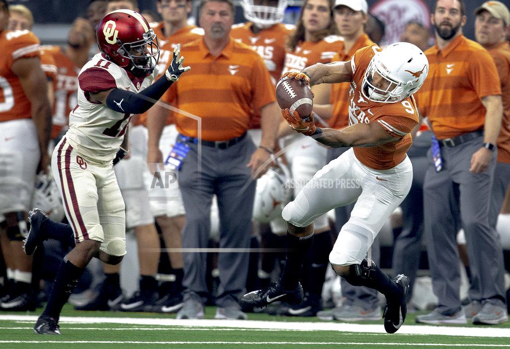 Nick Wagner Texas wide receiver Collin Johnson (9) catches a pass in front of Oklahoma cornerback Parnell Motley (11) during the Big 12 Conference championship NCAA college football game in Arlington, Texas, on Saturday, Dec. 1, 2018. (Nick Wagner/Austin American-Statesman via AP)