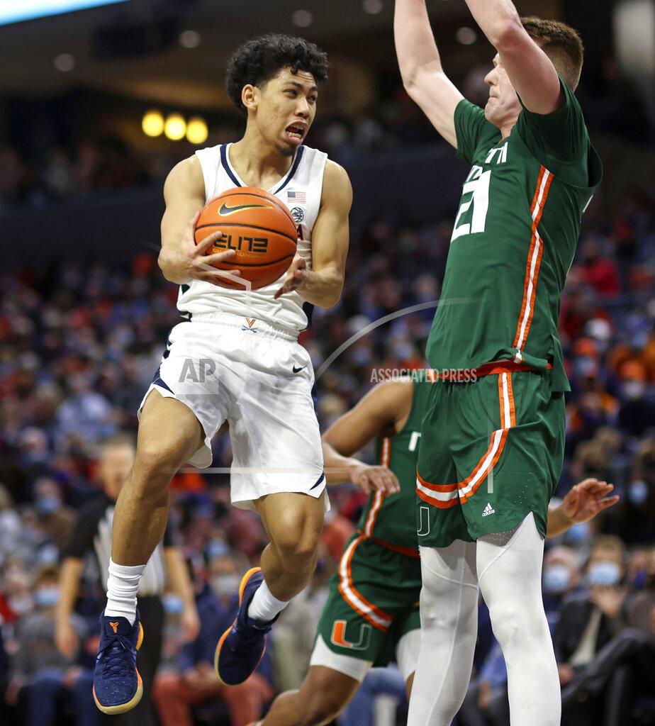 Andrew Shurtleff Virginia guard Kihei Clark (0) passes the ball next to Miami forward Sam Waardenburg (21) during an NCAA college basketball game in Charlottesville, Va., Saturday, Feb. 5, 2022. (AP Photo/Andrew Shurtleff)