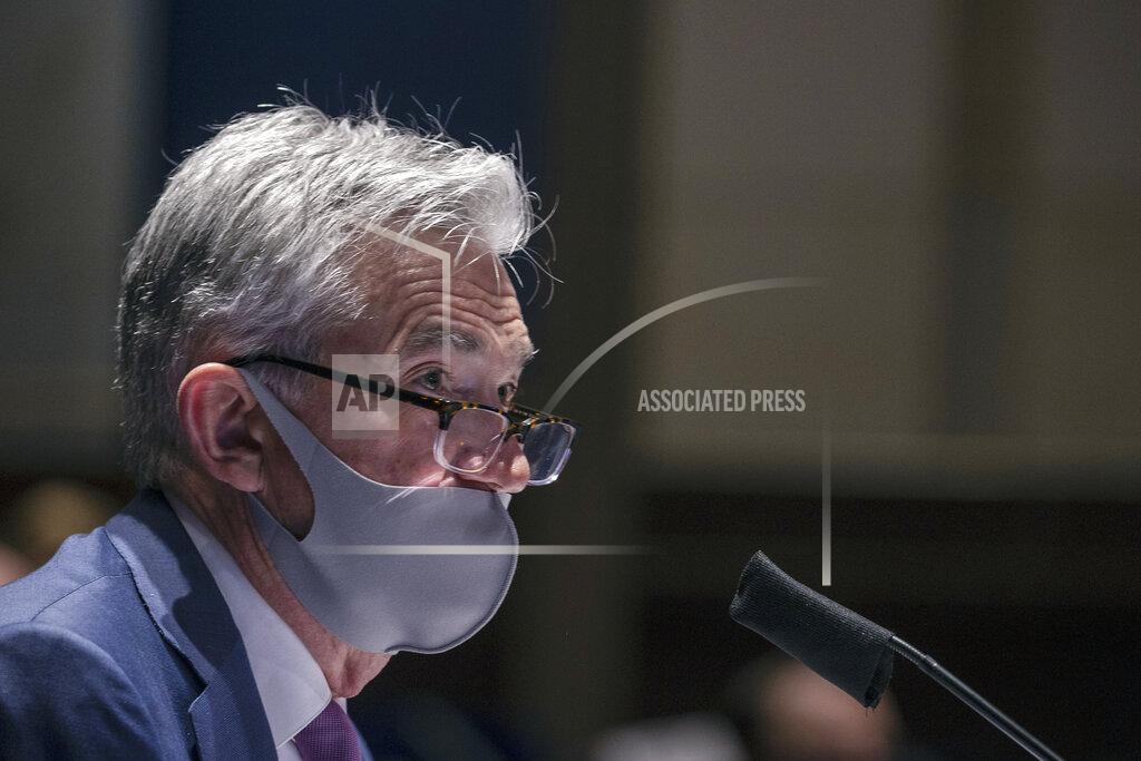 FILE - In this June 30, 2020 file photo, Federal Reserve Chair Jerome Powell testifies during a House Financial Services Committee hearing on the coronavirus response on Capitol Hill in Washington. U.S. consumers lifted their spending in May and June but businesses remained cautious because of the tremendous uncertainty surrounding the economic outlook, Federal Reserve officials said at a policy meeting last month. The nascent economic recovery faces several risks, Fed officials said in discussions during their most recent meeting on July 28-29. (Tasos Katopodis/Pool via AP)