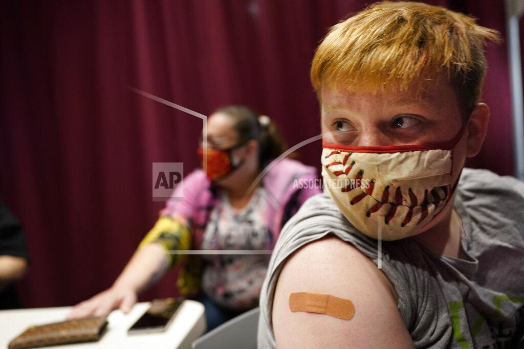 Robert F. Bukaty Jacob Conary, 15, listens to advice from a medical assistant after receiving his first shot of the COVID-19 vaccination, Wednesday, May 12, 2021, in Auburn, Maine. Vaccination clinics in Maine recently opened up to 12 to 15-year-olds. (AP Photo/Robert F. Bukaty)