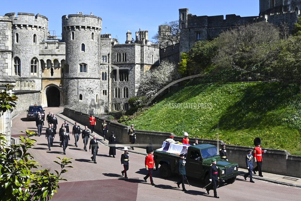 Leon Neal Britain's Prince Charles, from front left, Princess Anne, Prince Andrew. Prince Edward, Prince William, Peter Phillips, Prince Harry, Earl of Snowdon, Tim Laurence and Queen Elizabeth II, in car at rear, follow the coffin as it makes it's way past the Round Tower during the funeral of Britain's Prince Philip inside Windsor Castle in Windsor, England Saturday April 17, 2021. (Leon Neal/Pool via AP)