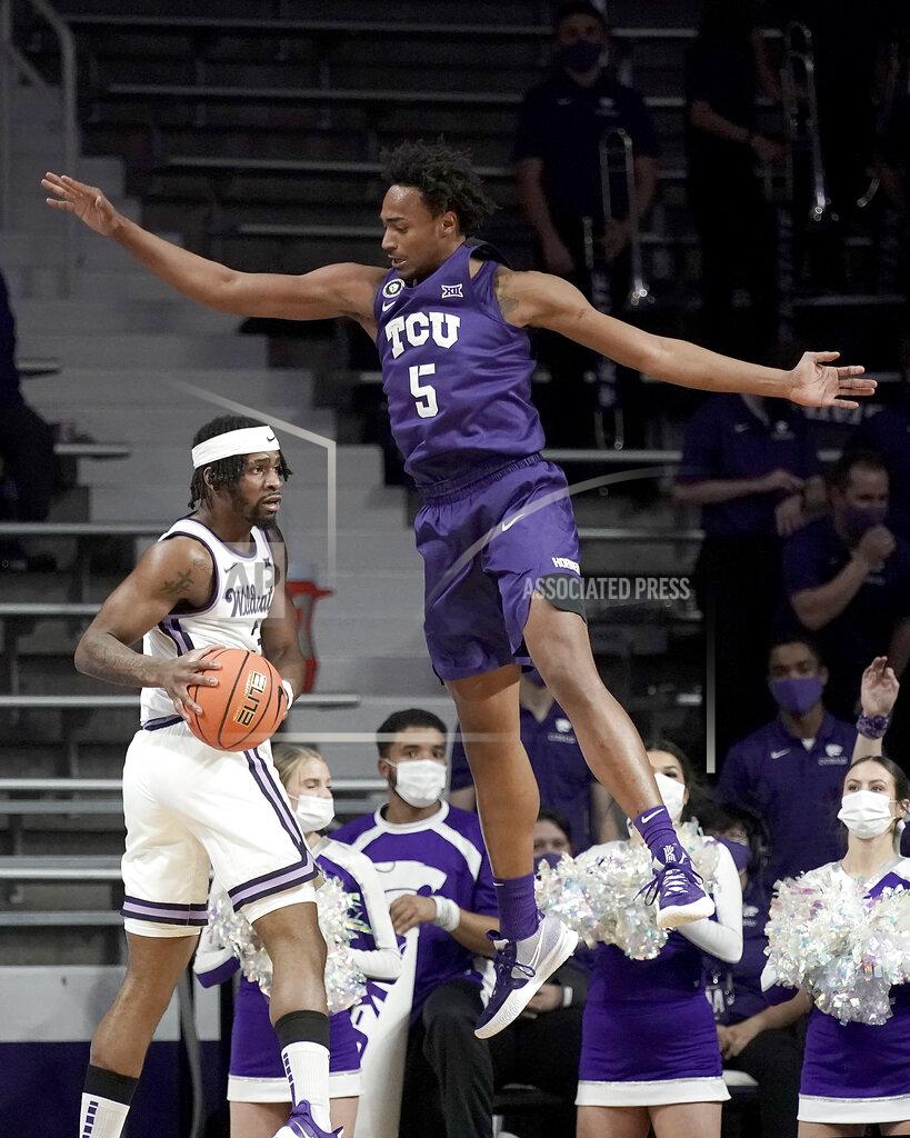 Charlie Riedel Kansas State guard Selton Miguel, left, looks to pass around TCU forward Chuck O'Bannon Jr. (5) during the first half of an NCAA college basketball game Wednesday, Jan. 12, 2022, in Manhattan, Kan. (AP Photo/Charlie Riedel)