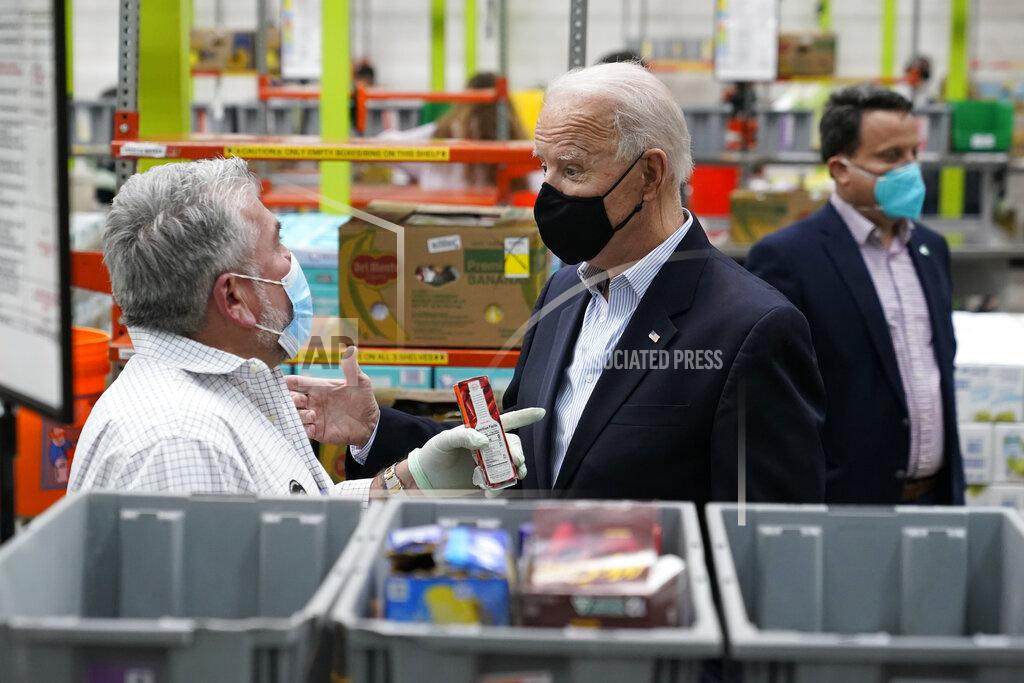 Patrick Semansky President Joe Biden talks with a volunteer at the Houston Food Bank, Friday, Feb. 26, 2021, in Houston. (AP Photo/Patrick Semansky)