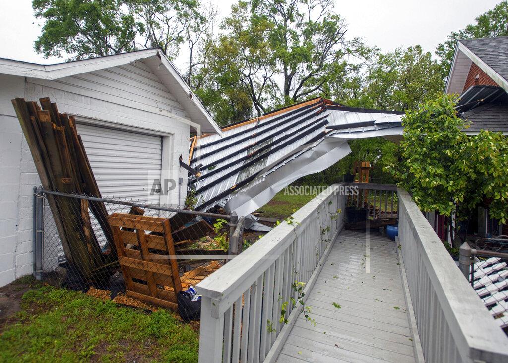 John Blackie A powerful storm ripped off the roof of Emerald Coast Brewing on West Government Street in Pensacola, Fla., on Saturday, April 10, 2021. Part of the roof landed at the business next door. (John Blackie/Pensacola News Journal via AP)