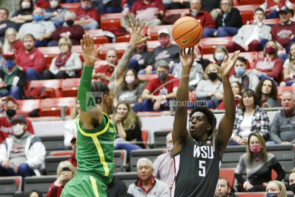 Young Kwak Washington State guard TJ Bamba, right, shoots while defended by Oregon guard Rivaldo Soares during the second half of an NCAA college basketball game, Saturday, March 5, 2022, in Pullman, Wash. Washington State won 94-74. (AP Photo/Young Kwak)