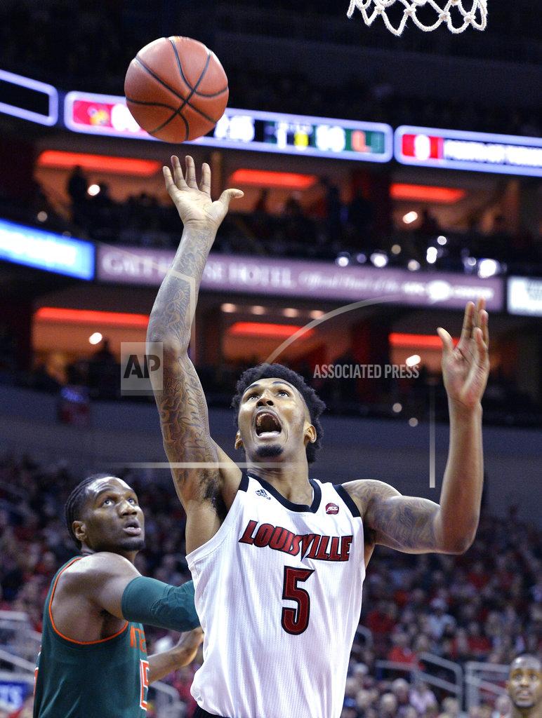 Timothy D. Easley Louisville center Malik Williams (5) attempts a shot away from the defense of Miami center Ebuka Izundu (15) during the second half of an NCAA college basketball game in Louisville, Ky., Sunday, Jan. 6, 2019. Louisville won 90-73. (AP Photo/Timothy D. Easley)