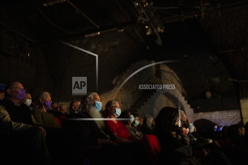 Maya Alleruzzo The audience wearing protective face masks watches on opening night at the Khan Theater during a performance where all guests were required to show proof of receiving a COVID-19 vaccination or full recovery from the virus, in Jerusalem, Tuesday, Feb. 23, 2021. (AP Photo/Maya Alleruzzo)