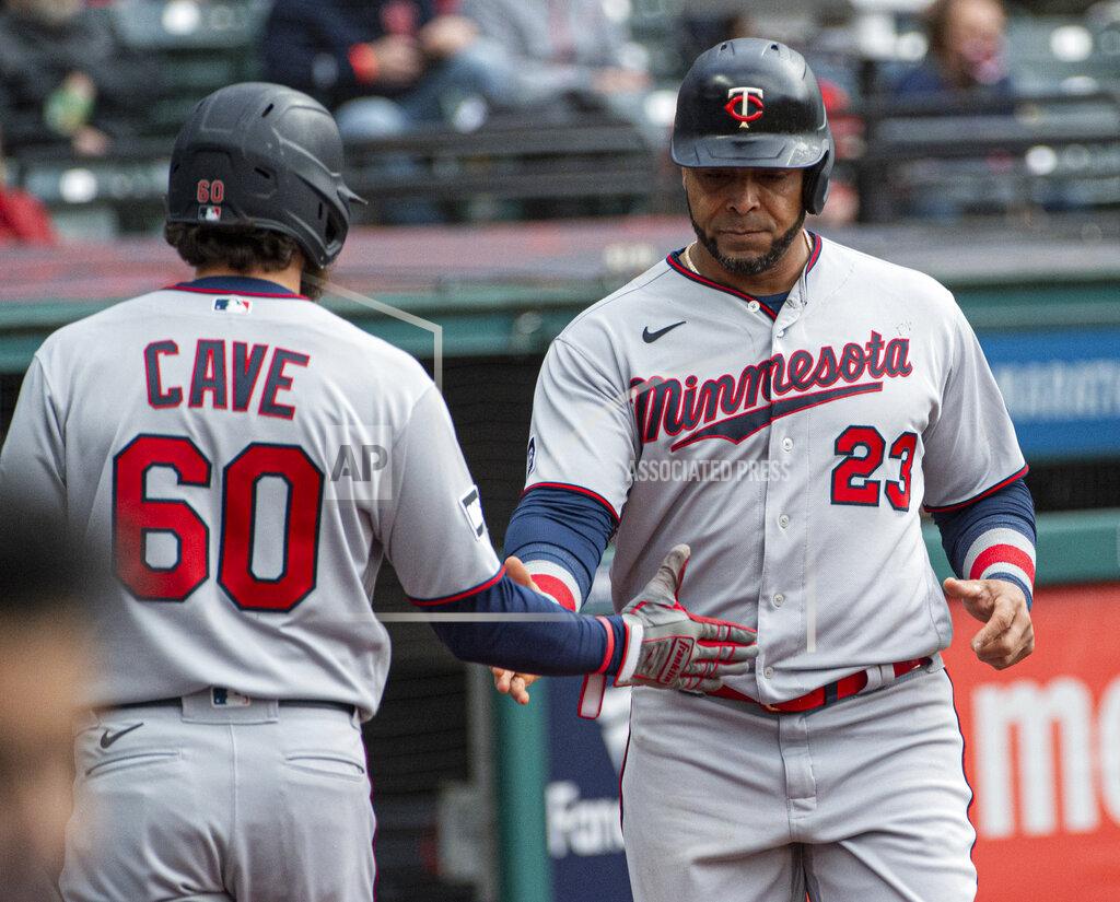 Phil Long Minnesota Twins' Nelson Cruz is greeted by teammate Jake Cave after scorning on a sacrifice fly by Jorge Polanco during the fourth inning of a baseball game against the Cleveland Indians in Cleveland, Monday, April 26, 2021. (AP Photo/Phil Long)
